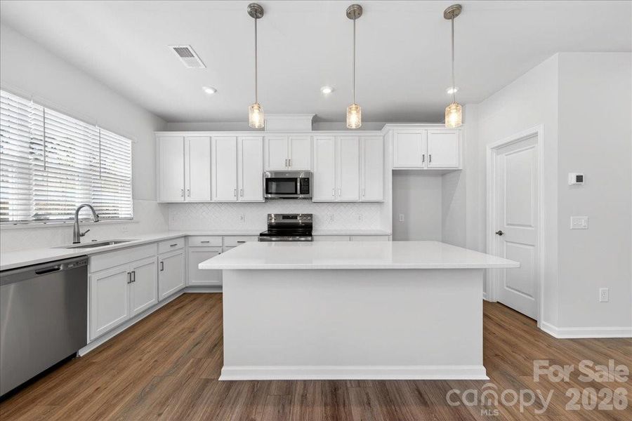 White kitchen cabinets and white quartz countertops