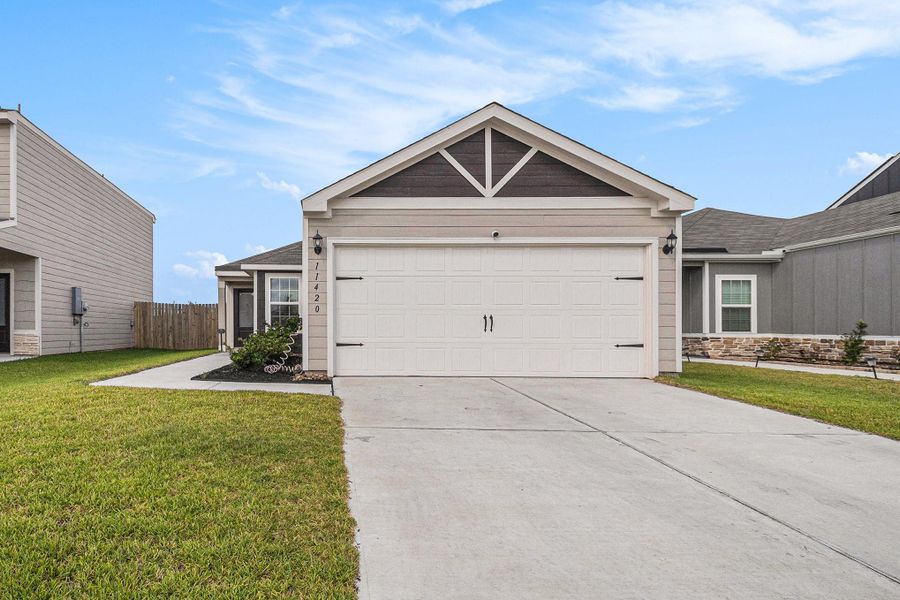 Front exterior of a new home in Park Vista at El Tesoro, Houston, TX, highlighting curb appeal (Image 1).