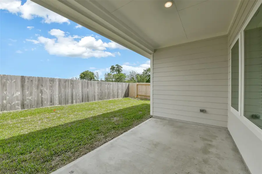 Exterior details and patio area of a home in King Oaks Village, Baytown (Image 4).