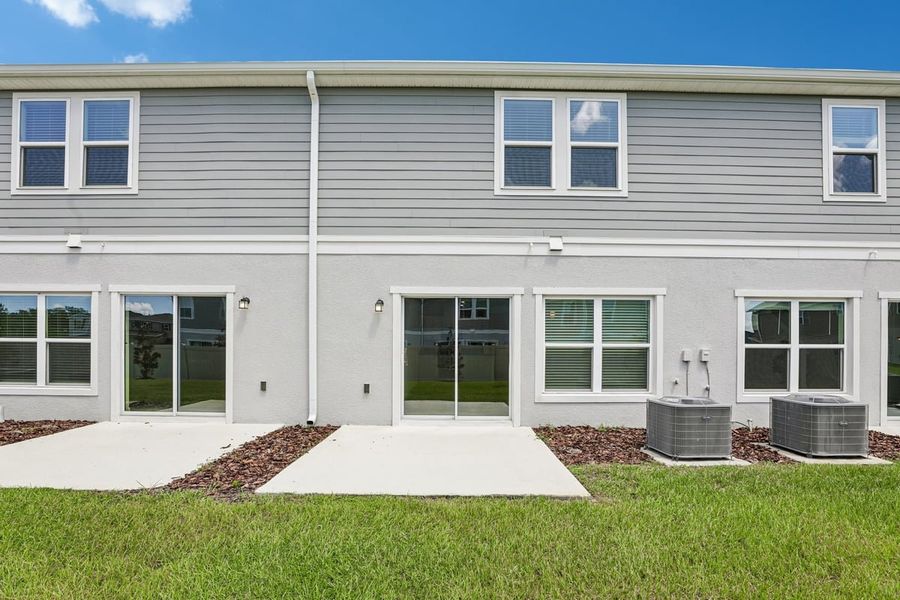 Exterior details and patio area of a home in Reserve at Forest Lake Townhomes, Lake Wales (Image 3).