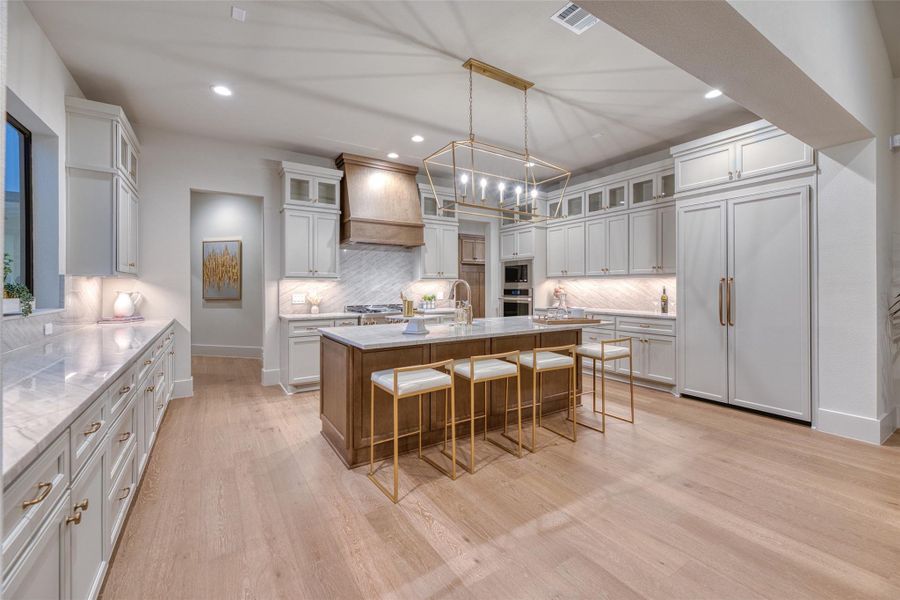 Cooks dream with an oversized island, built in refrigerator and a ton of storage and work space. Cooks dream with an oversized island, built in refrigerator and a ton of storage and work space.