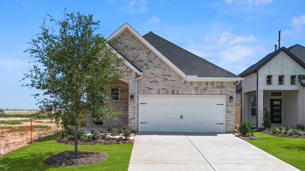 Front exterior of a new home in Jordan Ranch, Fulshear, TX, highlighting curb appeal (Image 24). Front exterior of a new home in Jordan Ranch, Fulshear, TX, highlighting curb appeal (Image 24).