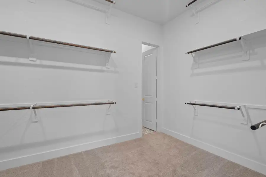 The enormous main closet with 3 rows of hanging rods The enormous main closet with 3 rows of hanging rods