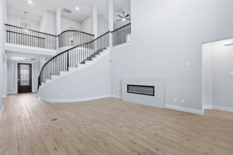 Living room view showcasing the staircase, modern flooring, and open layout.