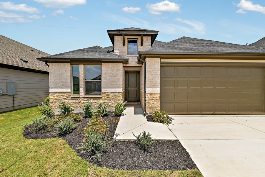 Front exterior of a new home in Prairie Winds, Hutto, TX, highlighting curb appeal (Image 2). Front exterior of a new home in Prairie Winds, Hutto, TX, highlighting curb appeal (Image 2).