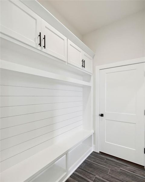 Mudroom with dark hardwood / wood-style flooring