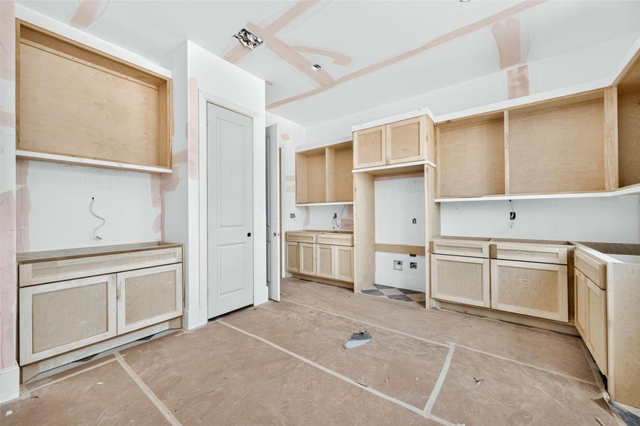 Laundry room comes equipped with a sink and storage closet