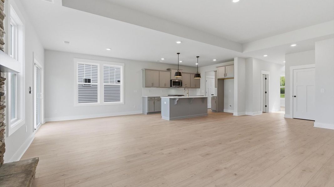 Exceptional family space featuring tray ceiling, hardwood flooring, and tasteful finishes throughout at the Foxbank community