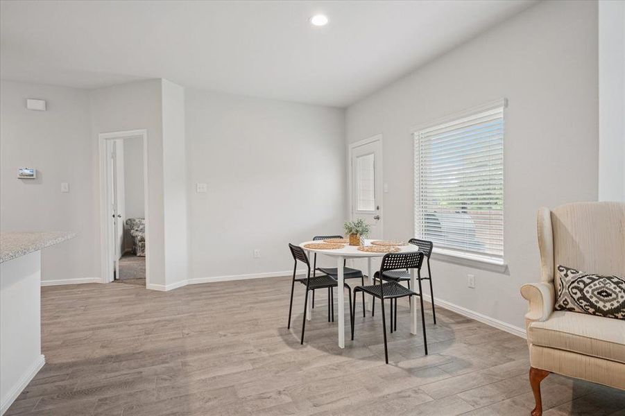 Dining space with light wood-style flooring and recessed lighting. Dining space with light wood-style flooring and recessed lighting.