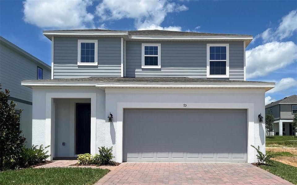 Front exterior of a new home in Trinity Lakes, Groveland, FL, highlighting curb appeal (Image 1). Front exterior of a new home in Trinity Lakes, Groveland, FL, highlighting curb appeal (Image 1).