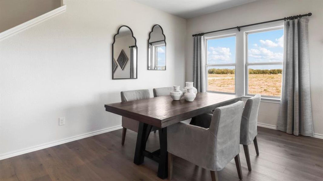 Light-filled room featuring wood-finish flooring, white baseboards, and neutral wall paint