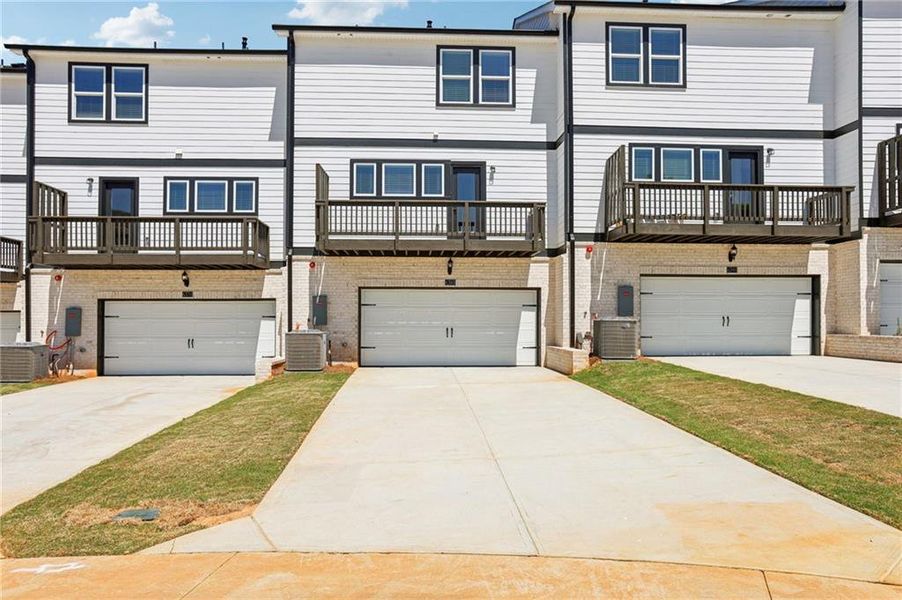 Front exterior of a new home in Hemingway - Highland Series, Cumming, GA, highlighting curb appeal (Image 22). Front exterior of a new home in Hemingway - Highland Series, Cumming, GA, highlighting curb appeal (Image 22).