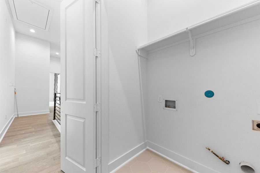 Upstairs laundry area for added convenience, centrally located near the bedrooms.
