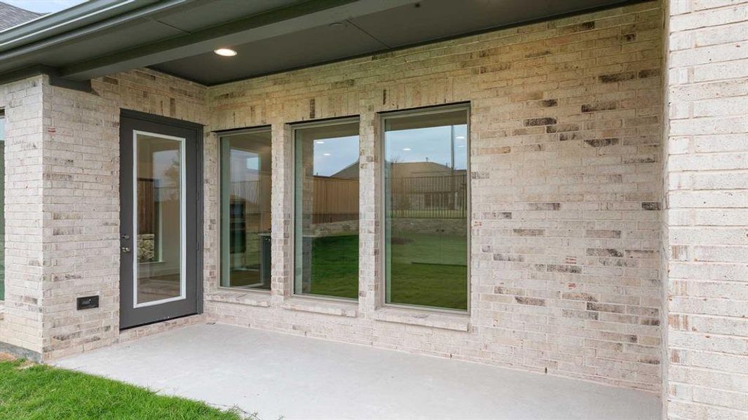 Doorway to property featuring a patio area