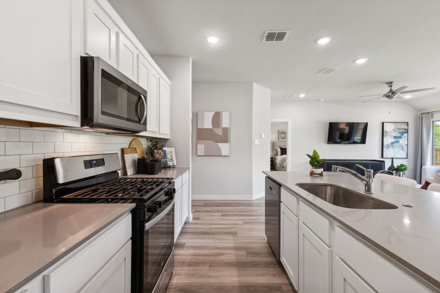 Kitchen in the Emmy II home plan by Trophy Signature Homes - REPRESENTATIVE PHOTO