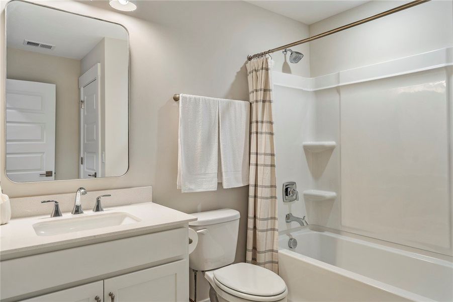 This bright bathroom features a vanity with a slee