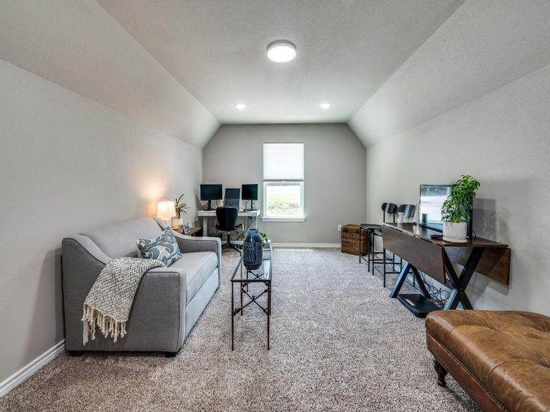 Office area with carpet floors, lofted ceiling, and baseboards Office area with carpet floors, lofted ceiling, and baseboards