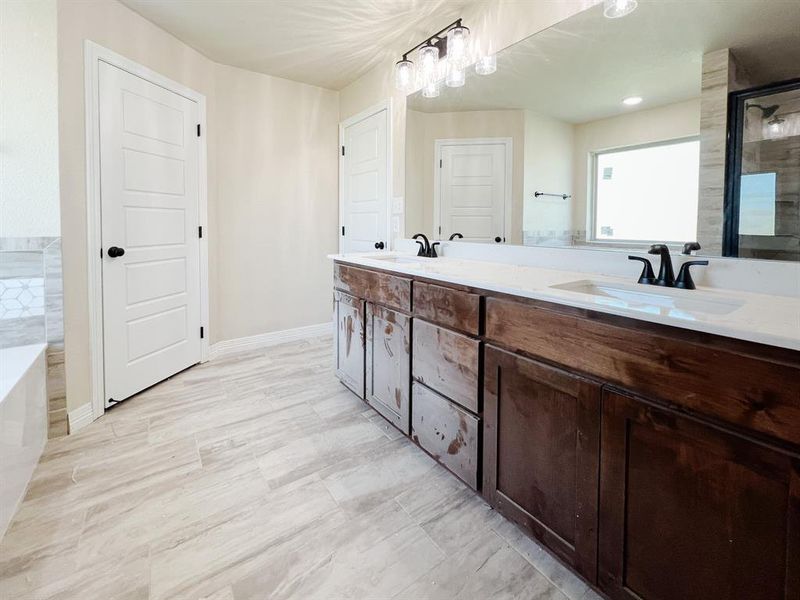 Full bathroom with double vanity, a bath, and an enclosed shower Full bathroom with double vanity, a bath, and an enclosed shower