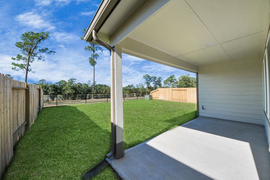 Experience outdoor living at its finest on this expansive covered patio, thoughtfully designed for BBQs and delightful outdoor dining.