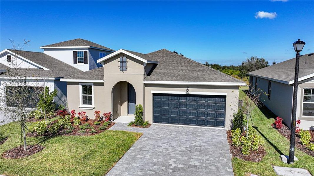 Front exterior of a new home in Turnleaf, Punta Gorda, FL, highlighting curb appeal (Image 20).