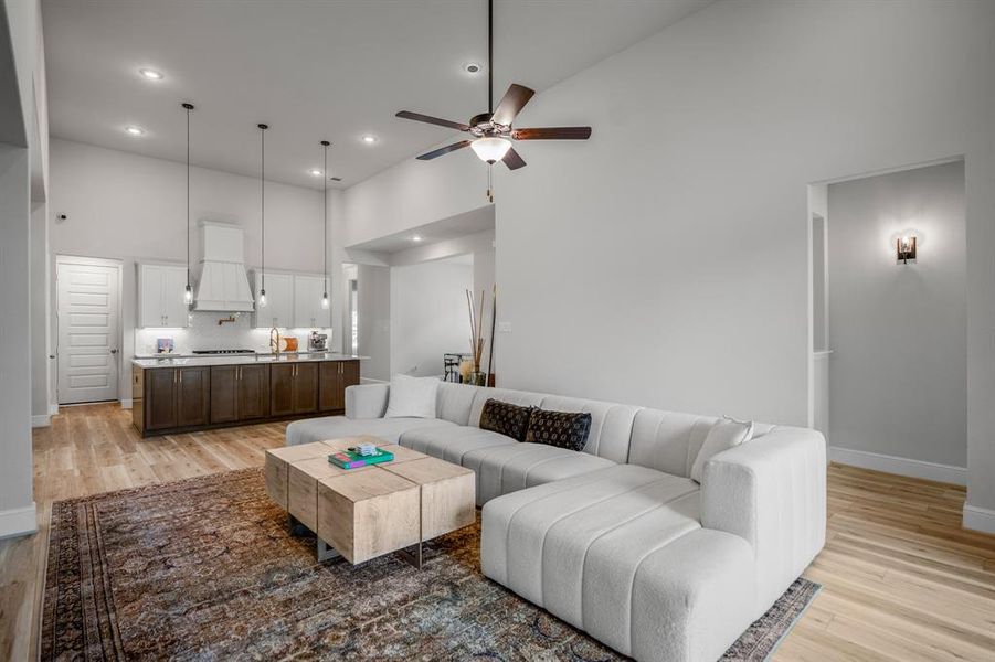 Gather the family and guests together in your huge living room! Featuring soaring high ceilings, dark stained ceiling fan, gorgeous floors, and an open layout.