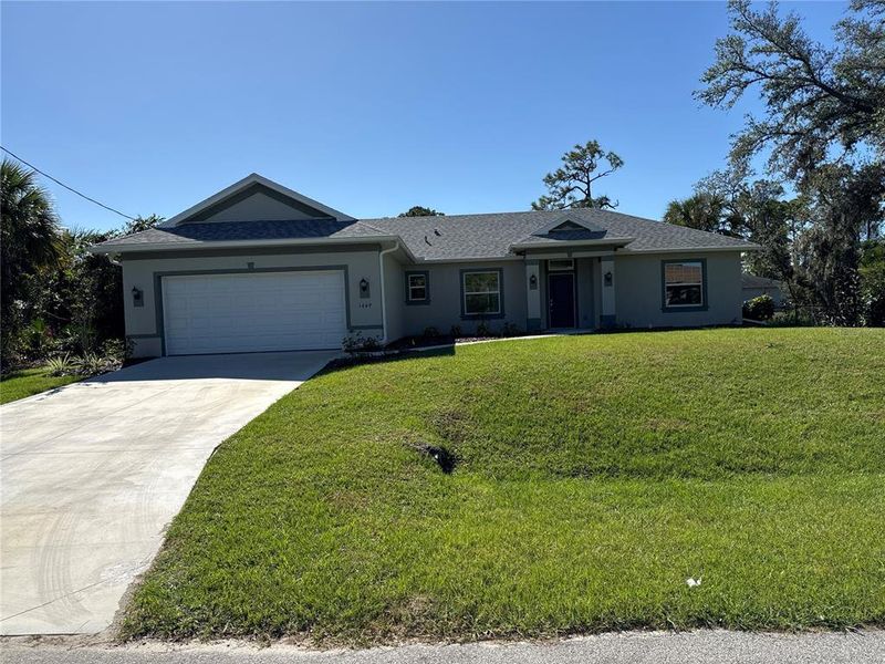 Front exterior of a new home in , North Port, FL, highlighting curb appeal (Image 1).