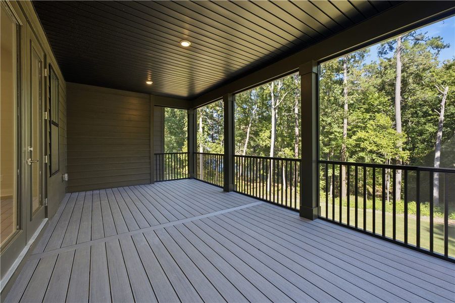 A spacious covered deck overlooks serene surroundi