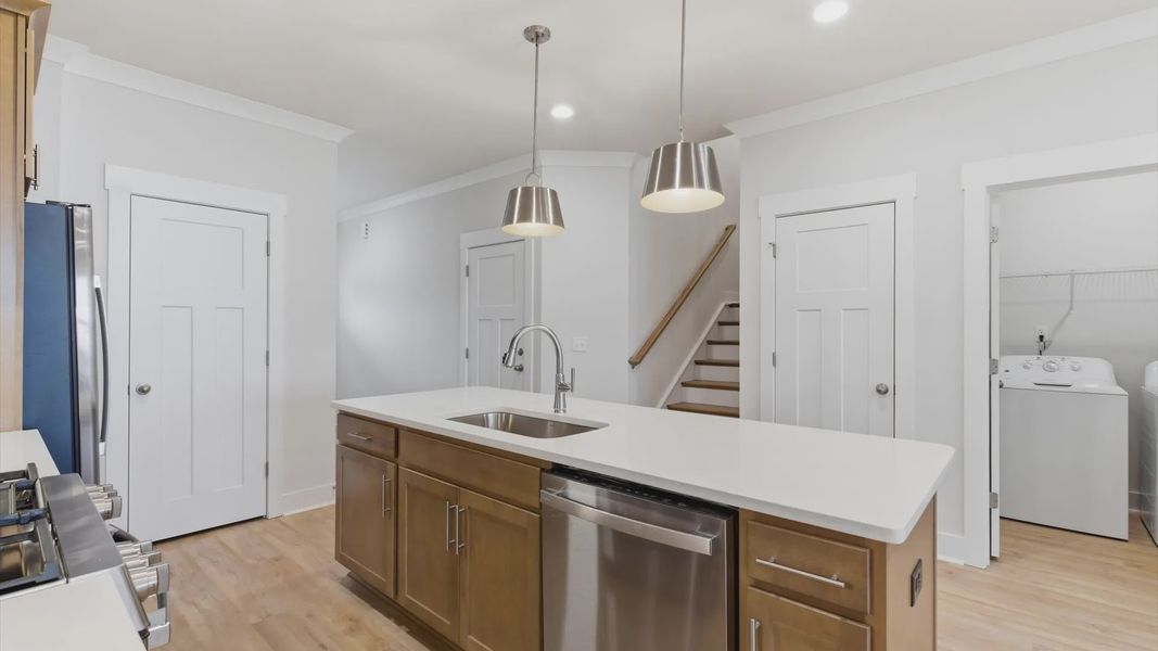 Exclusive kitchen design with large island, pendant lights, and tasteful finishes throughout located at Pelham Crossing