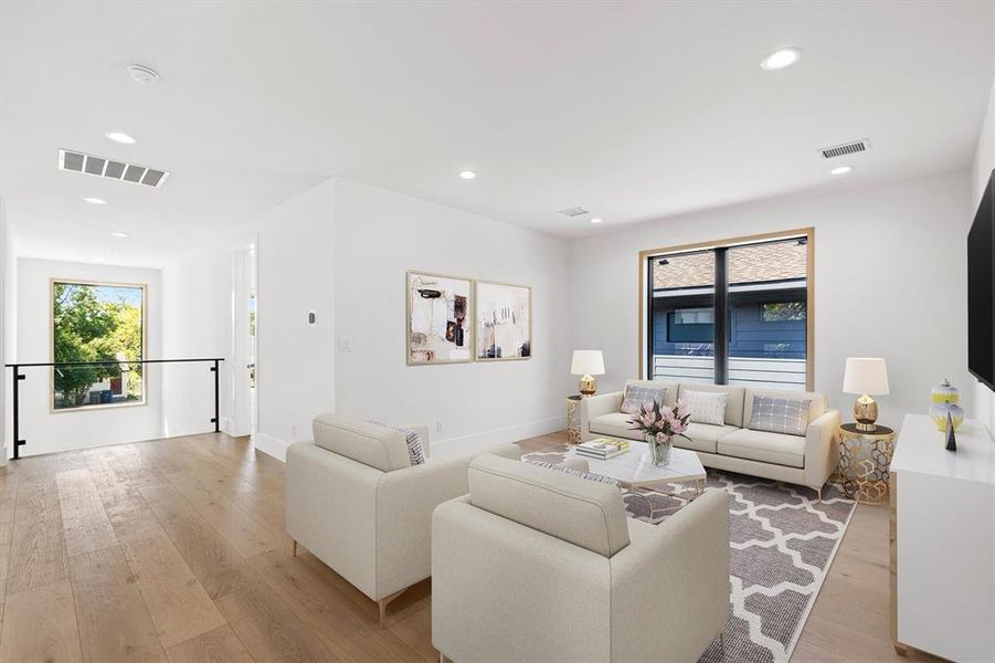 Living room with light hardwood / wood-style floors