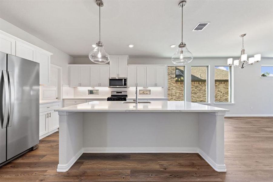 The oversized island is the hub of your new dream kitchen and the perfect place for friends and family to gahter!