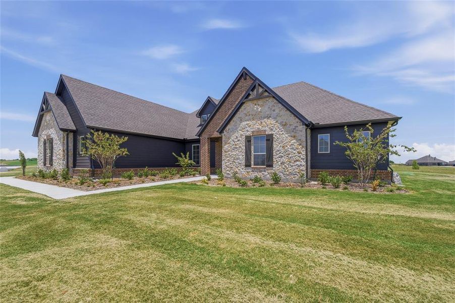 Contemporary exterior featuring dark siding, stone accents, gabled rooflines, and a concrete pathway Contemporary exterior featuring dark siding, stone accents, gabled rooflines, and a concrete pathway