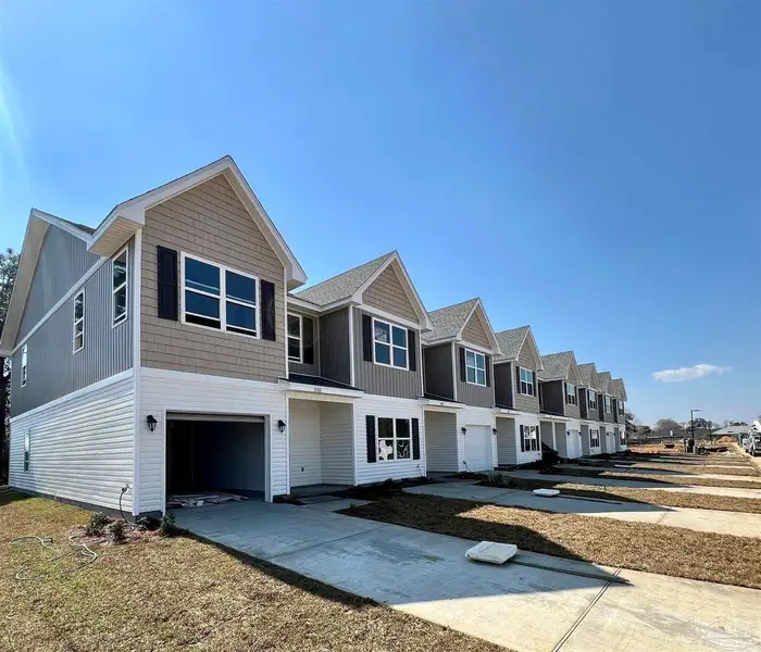 Front exterior of a new home in Lexlee Estates, Pensacola, FL, highlighting curb appeal (Image 1).