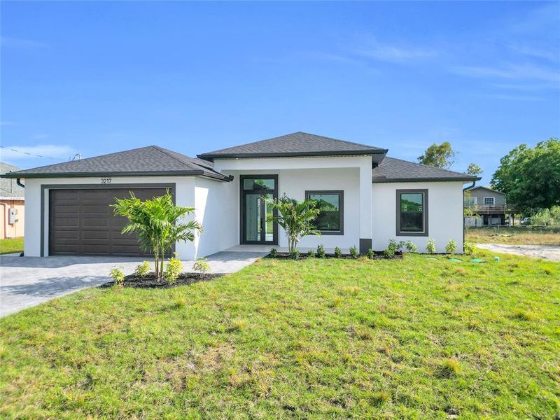 Front exterior of a new home in , Lehigh Acres, FL, highlighting curb appeal (Image 1). Front exterior of a new home in , Lehigh Acres, FL, highlighting curb appeal (Image 1).