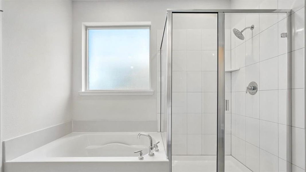 Bathroom featuring a built-in tub with chrome fixtures, a frosted window, and a glass-enclosed shower with white subway tile surround and a rainfall showerhead Bathroom featuring a built-in tub with chrome fixtures, a frosted window, and a glass-enclosed shower with white subway tile surround and a rainfall showerhead