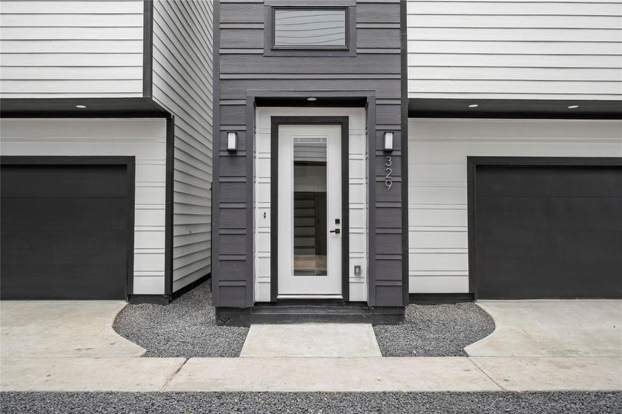 With modern finishes and fixtures inside and out, the front porch offers a welcoming entrance with an 8-foot glass panel door with internal blinds and two coach lights. The smart garage has a MyQ app and a separate storage room.