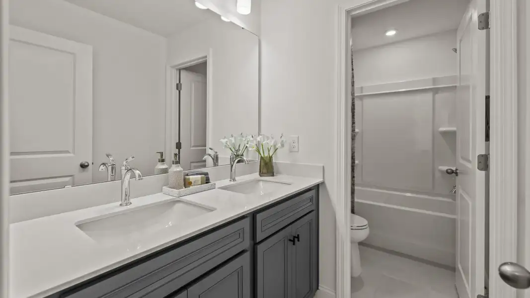 The Townsend Design secondary bathroom with dual-sink vanity and premium finishes. At Lakeside Glen by DRB Homes in York, SC The Townsend Design secondary bathroom with dual-sink vanity and premium finishes. At Lakeside Glen by DRB Homes in York, SC