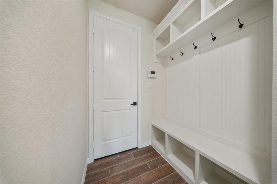 Mudroom with wood finish floors and baseboards