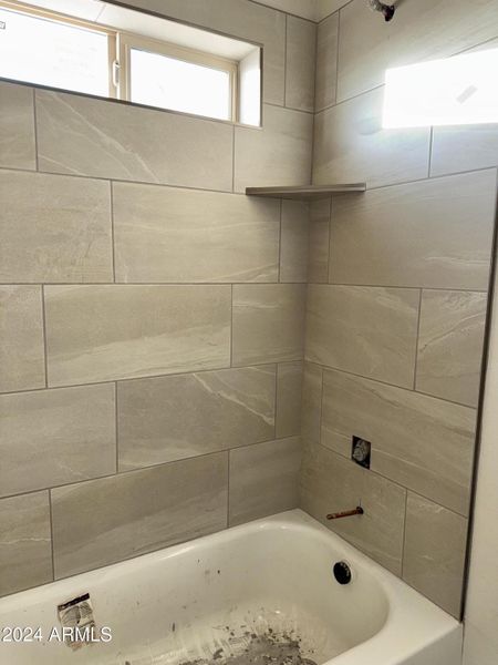 Guest bathroom with tile around tub