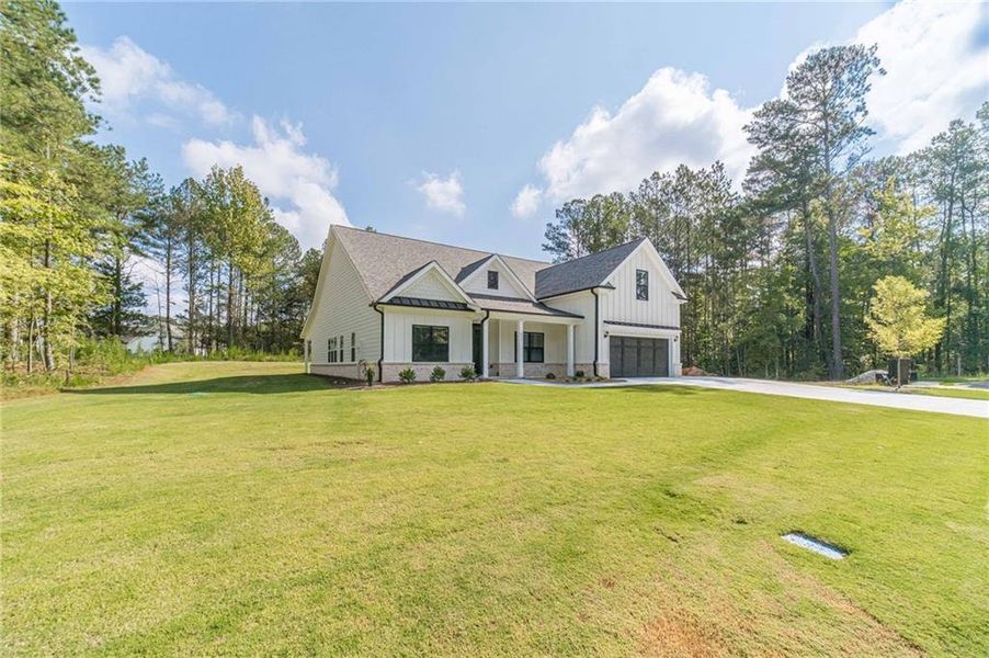 Front exterior of a new home in , Loganville, GA, highlighting curb appeal (Image 19).