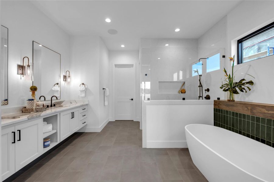 Bathroom with vanity, a freestanding tub, a walk in shower, recessed lighting, and light tile patterned floors