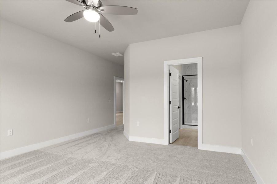 Unfurnished bedroom with light colored carpet, baseboards, ensuite bathroom, and a ceiling fan Unfurnished bedroom with light colored carpet, baseboards, ensuite bathroom, and a ceiling fan