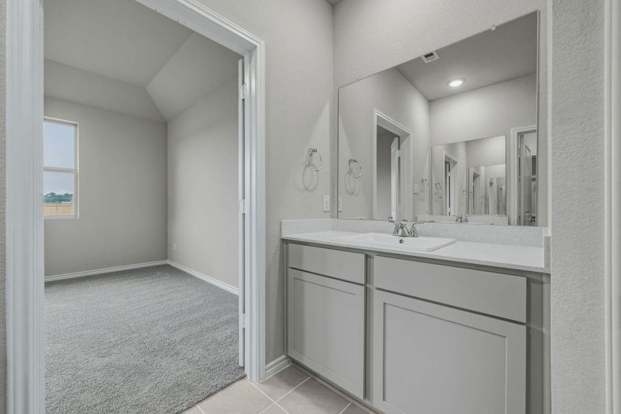 Primary Bathroom in the Cedar home plan by Trophy Signature Homes – REPRESENTATIVE PHOTO
