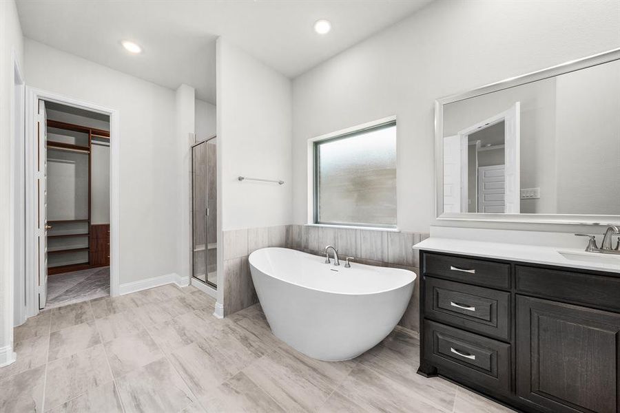 Bathroom featuring a wainscoted wall, a freestanding bath, vanity, recessed lighting, and a stall shower Bathroom featuring a wainscoted wall, a freestanding bath, vanity, recessed lighting, and a stall shower