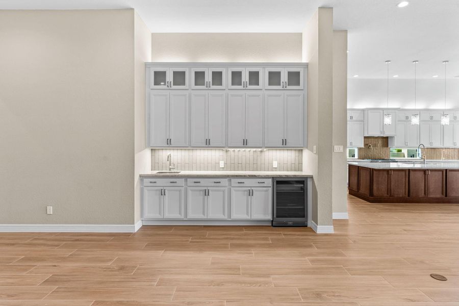 Stylish built-in cabinetry with beverage storage and display shelving, perfect for serving or showcasing glassware.