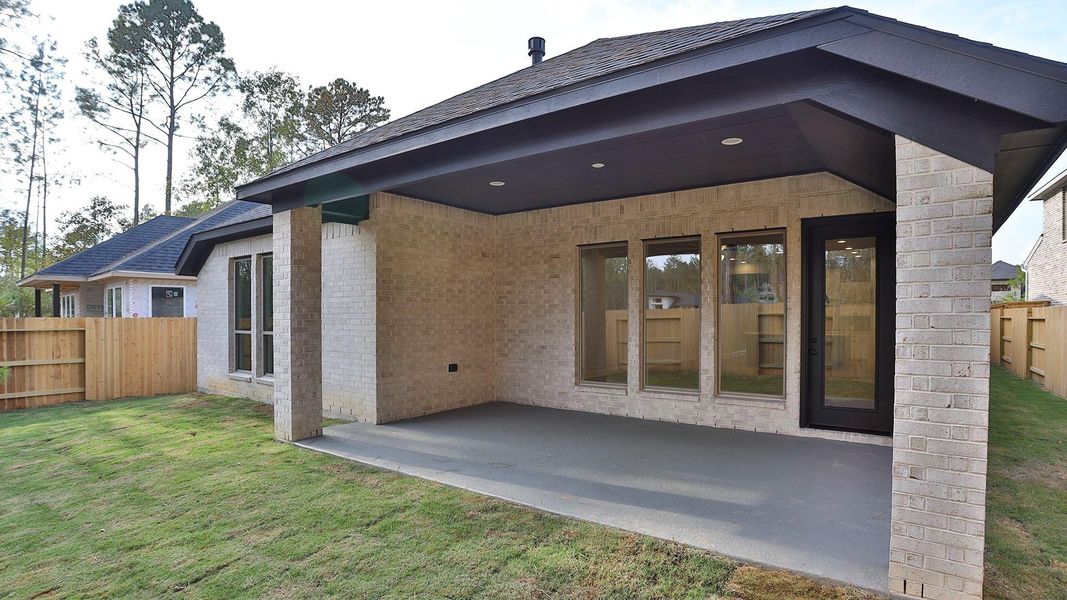 Exterior details and patio area of a home in Woodhavyn 50', Magnolia (Image 3).