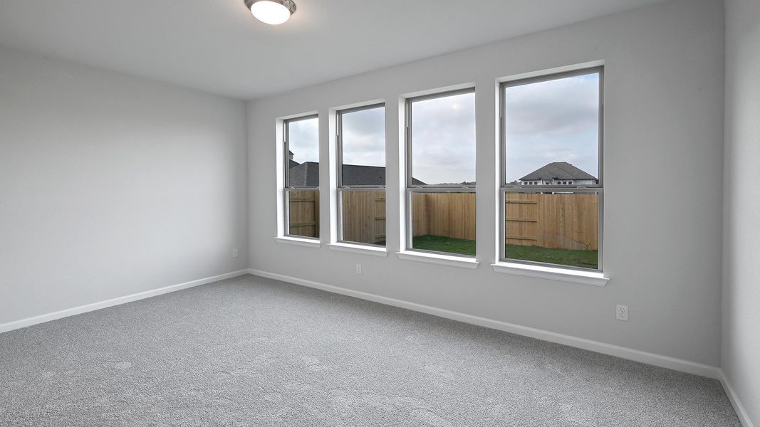Carpeted empty room featuring baseboards Carpeted empty room featuring baseboards
