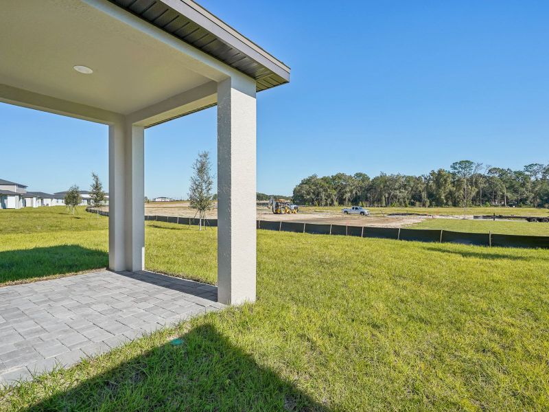 Exterior details and patio area of a home in The Reserve at Hammock Oaks - Signature Series, Lady Lake (Image 3).