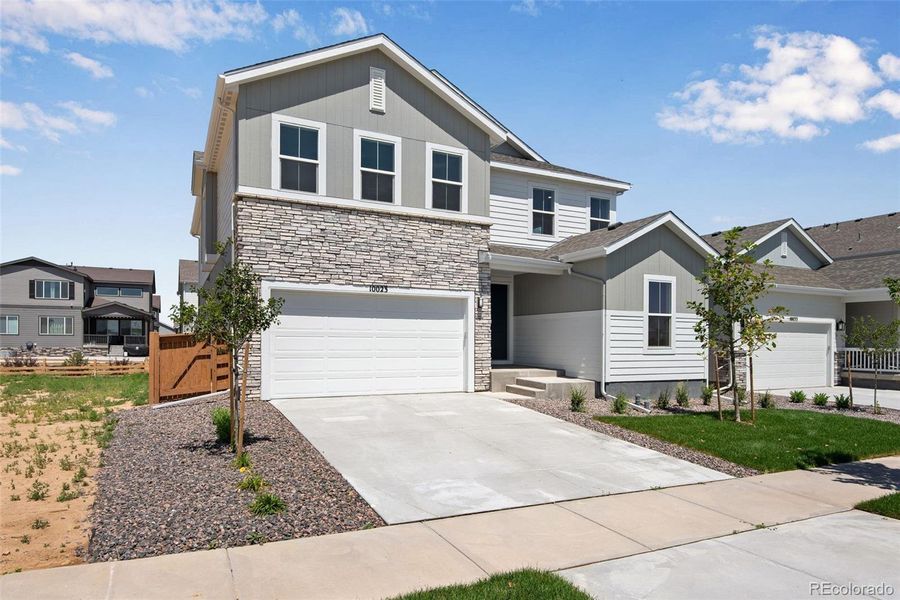Front exterior of a new home in Reunion Ridge, Commerce City, CO, highlighting curb appeal (Image 1).