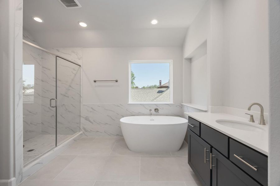Ensuite Elegance: Step into the primary suite's ensuite bathroom, boasting abundant space and luxurious finishes, including a spa-like shower adjacent to the elegant freestanding tub. Ensuite Elegance: Step into the primary suite's ensuite bathroom, boasting abundant space and luxurious finishes, including a spa-like shower adjacent to the elegant freestanding tub.