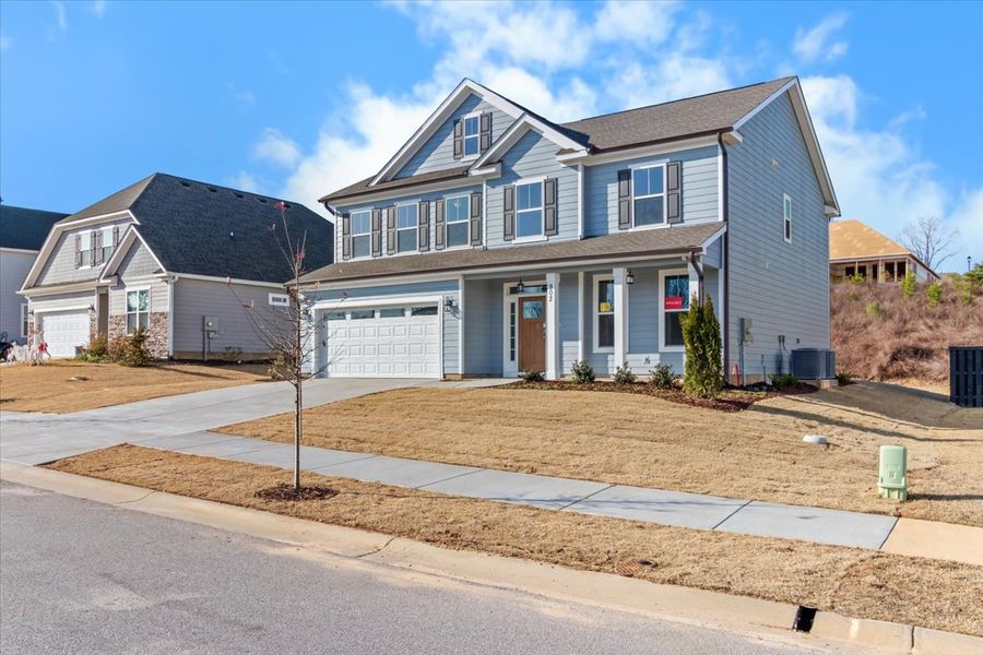 Front exterior of a new home in Crawford Creek, Grovetown, GA, highlighting curb appeal (Image 24). Front exterior of a new home in Crawford Creek, Grovetown, GA, highlighting curb appeal (Image 24).